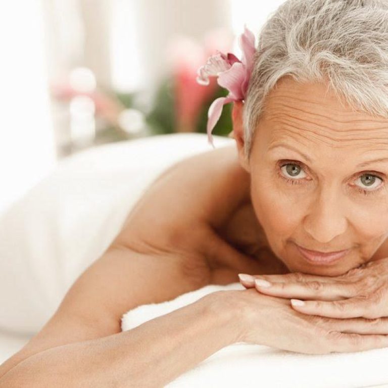 Senior woman relaxing on massage table, portrait
