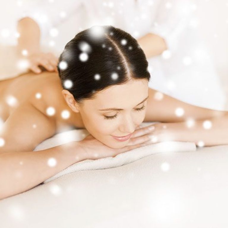 health and beauty concept - woman in spa salon getting massage