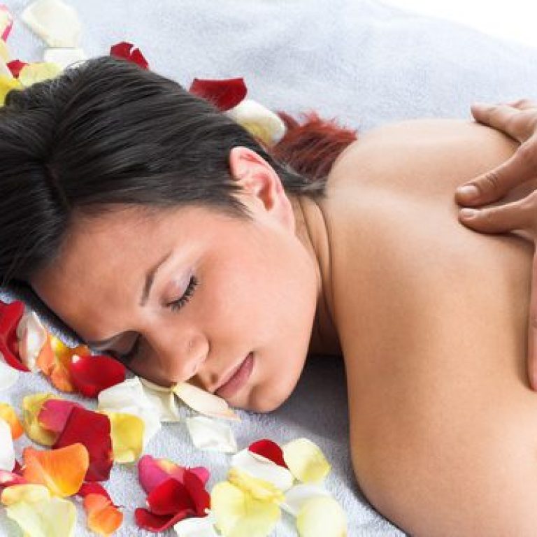 Woman getting a back massage in front of the white background